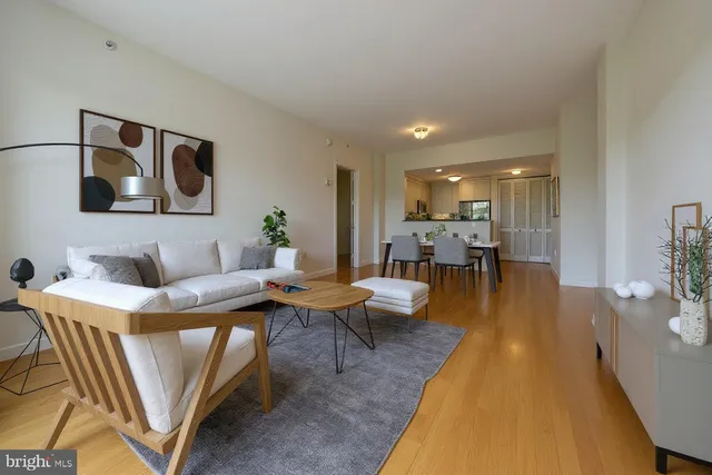 a living room with dining room and wooden floor