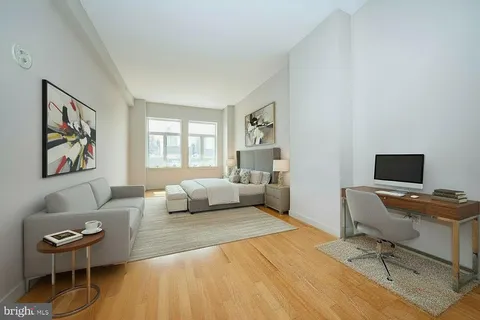 a bedroom with a bed and a couch