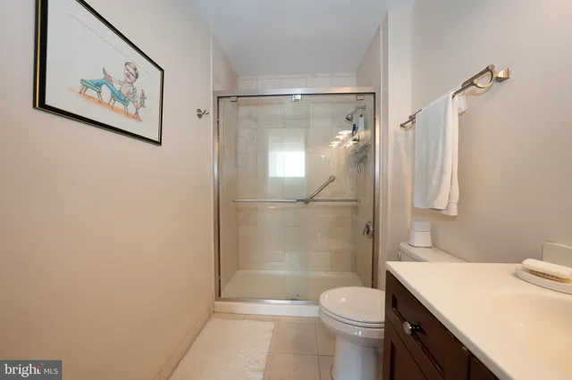 a bathroom with a toilet a sink and shower