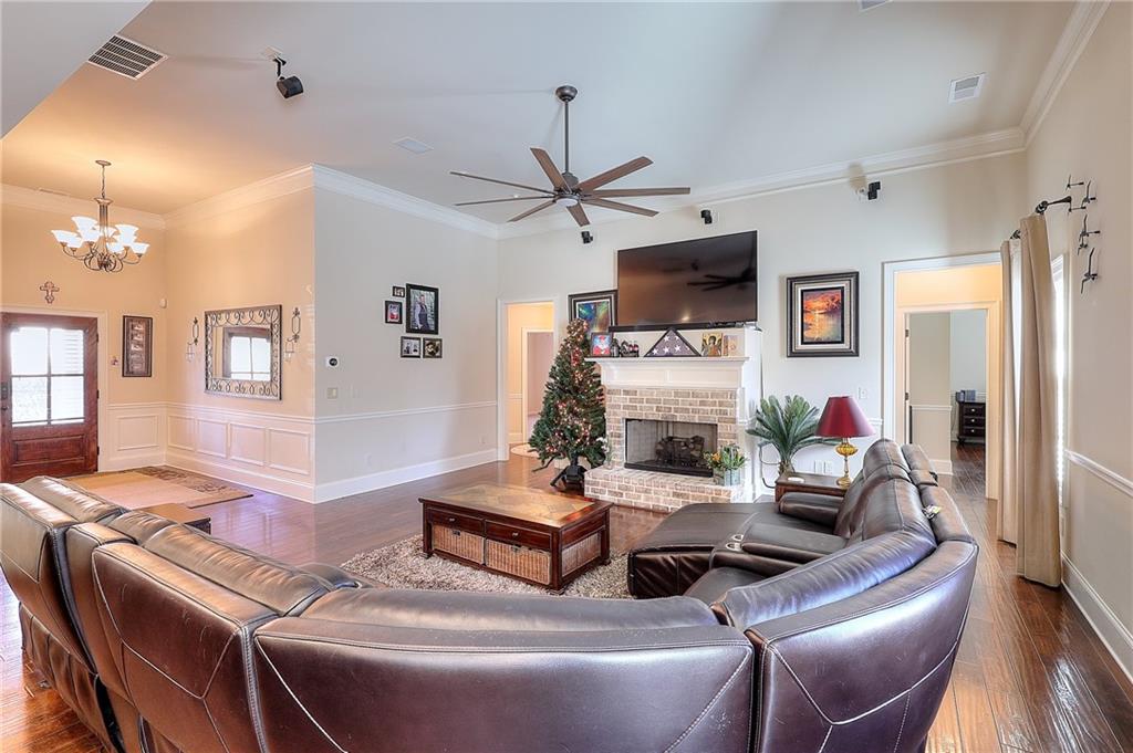 1079 Monticello Drive Monroe, GA 30655 - Photo 16 of 57 a living room with furniture a flat screen tv and a fireplace