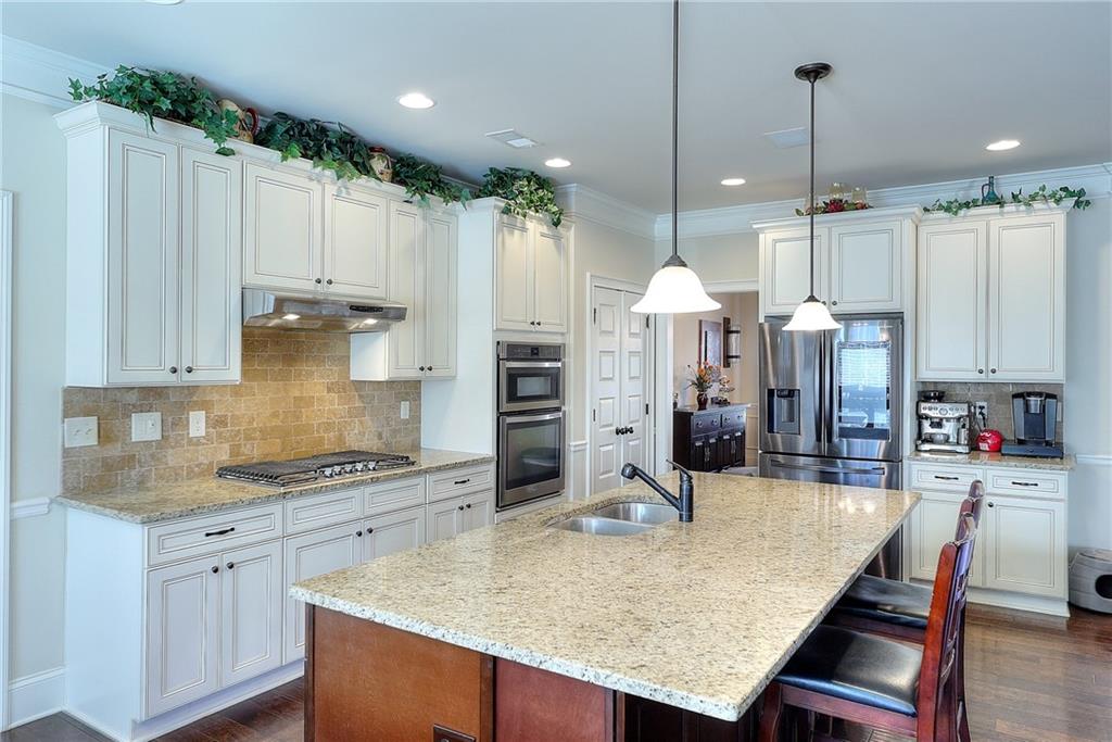 1079 Monticello Drive Monroe, GA 30655 - Photo 18 of 57 a kitchen with stainless steel appliances granite countertop a kitchen island a stove and a cabinets