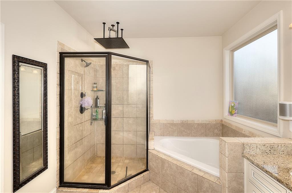 1079 Monticello Drive Monroe, GA 30655 - Photo 26 of 57 a bathroom with a bathtub and a shower