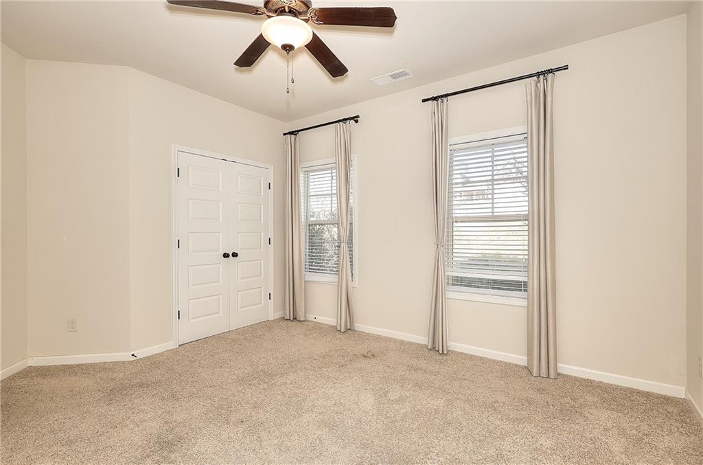 1079 Monticello Drive Monroe, GA 30655 - Photo 30 of 57 an empty room with chandelier fan