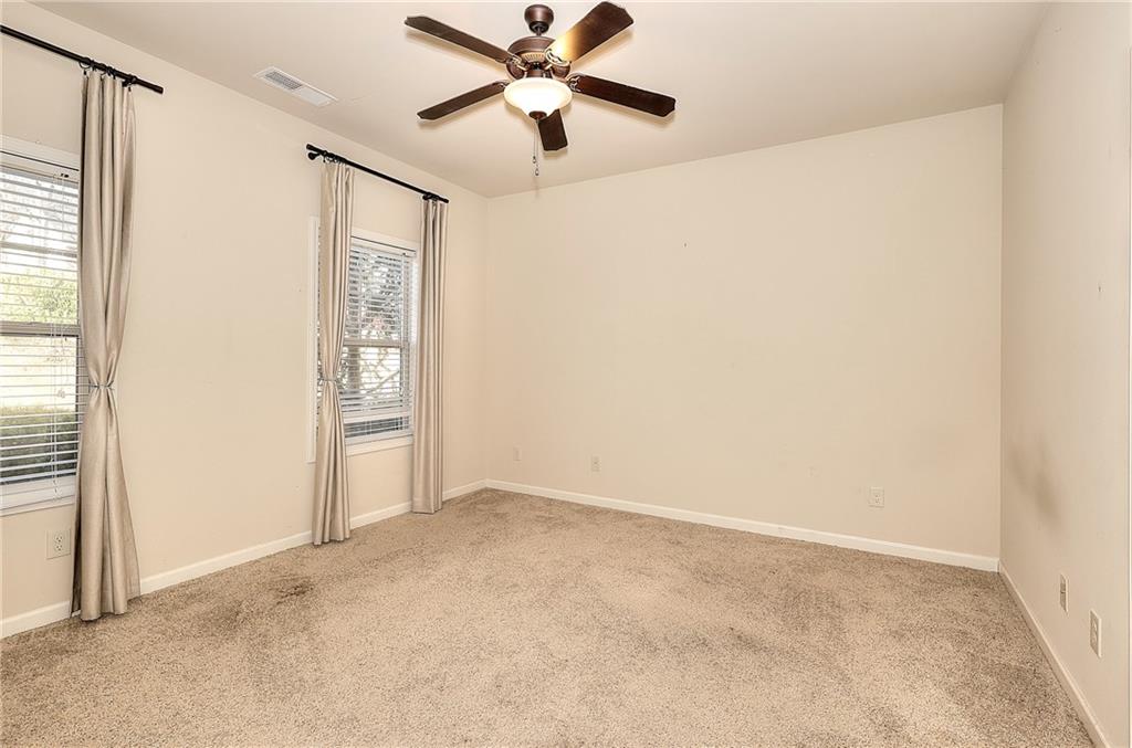 1079 Monticello Drive Monroe, GA 30655 - Photo 32 of 57 an empty room with windows and fan