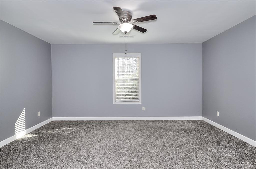 1079 Monticello Drive Monroe, GA 30655 - Photo 35 of 57 a view of a livingroom with a ceiling fan and window