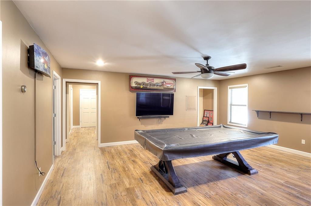 1079 Monticello Drive Monroe, GA 30655 - Photo 42 of 57 a workspace with wooden floor and a bookshelf
