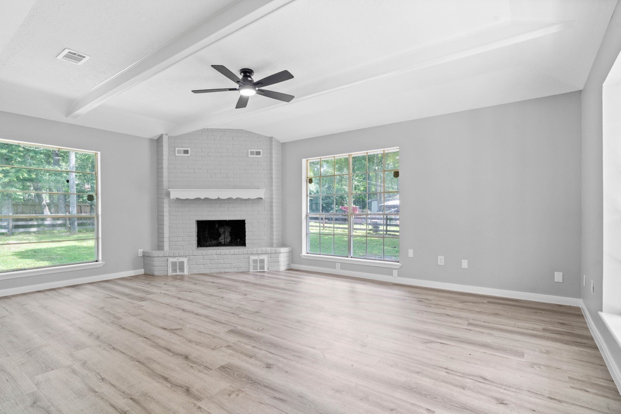 13400 Nicholson Road Conroe, TX 77303 - Photo 9 of 36 Living room with fan to keep cool and a fireplace to stay warm.