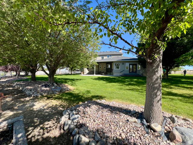 812 East Bates Cyn Road Tooele, UT 84074 - Photo 126 of 144 Expansive rear yard featuring a manicured lawn and mature shade trees