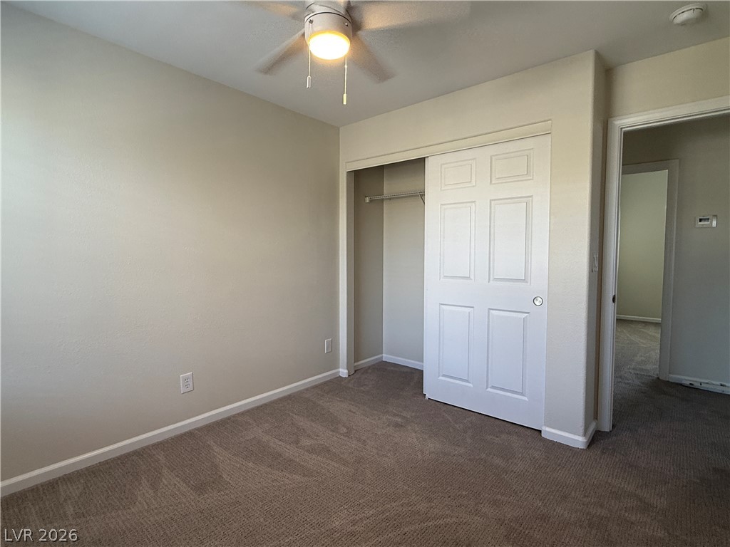 1908 Thunder Ridge Circle Henderson, NV 89012 - Photo 21 of 28 A well-kept sleeping space features a ceiling fan and a built-in closet with sliding doors.