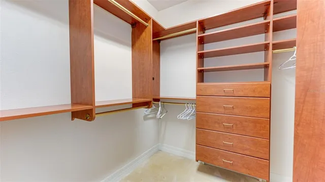a bedroom with a bed and a flat tv screen on dresser