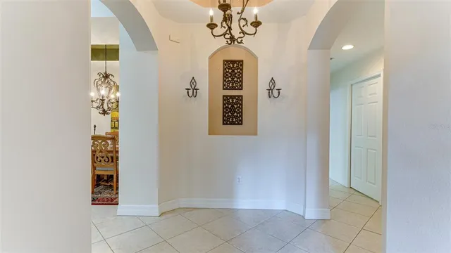 a view of a dining room with furniture and chandelier