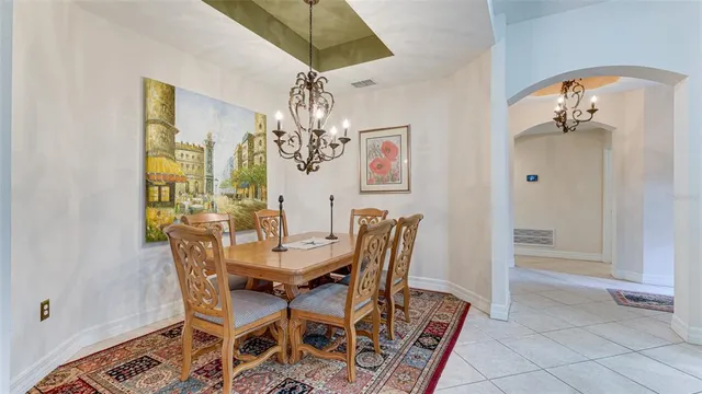a view of a dining room with furniture and chandelier