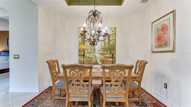 a living room with furniture ceiling fan and a large window