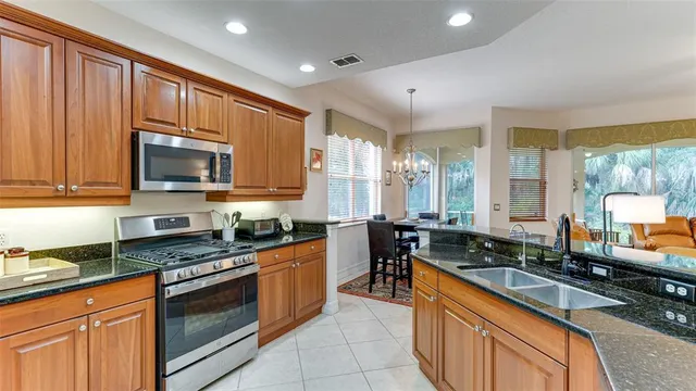 a kitchen with stainless steel appliances granite countertop a refrigerator and a stove