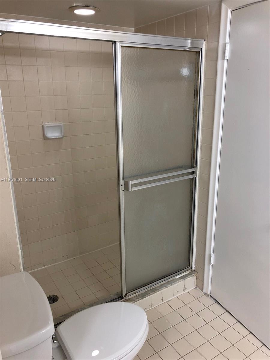 20840 San Simeon Way, Unit 702 Miami, FL 33179 - Photo 23 of 34 a bathroom with a toilet and a shower