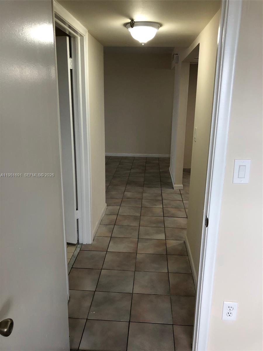 20840 San Simeon Way, Unit 702 Miami, FL 33179 - Photo 26 of 34 a view of a hallway