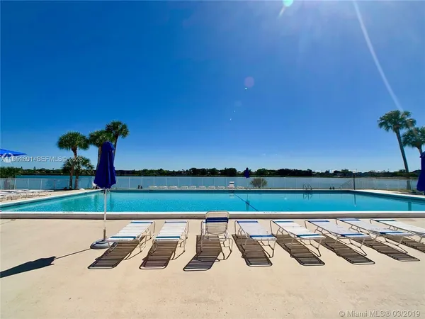 a view of swimming pool with outdoor seating and city view