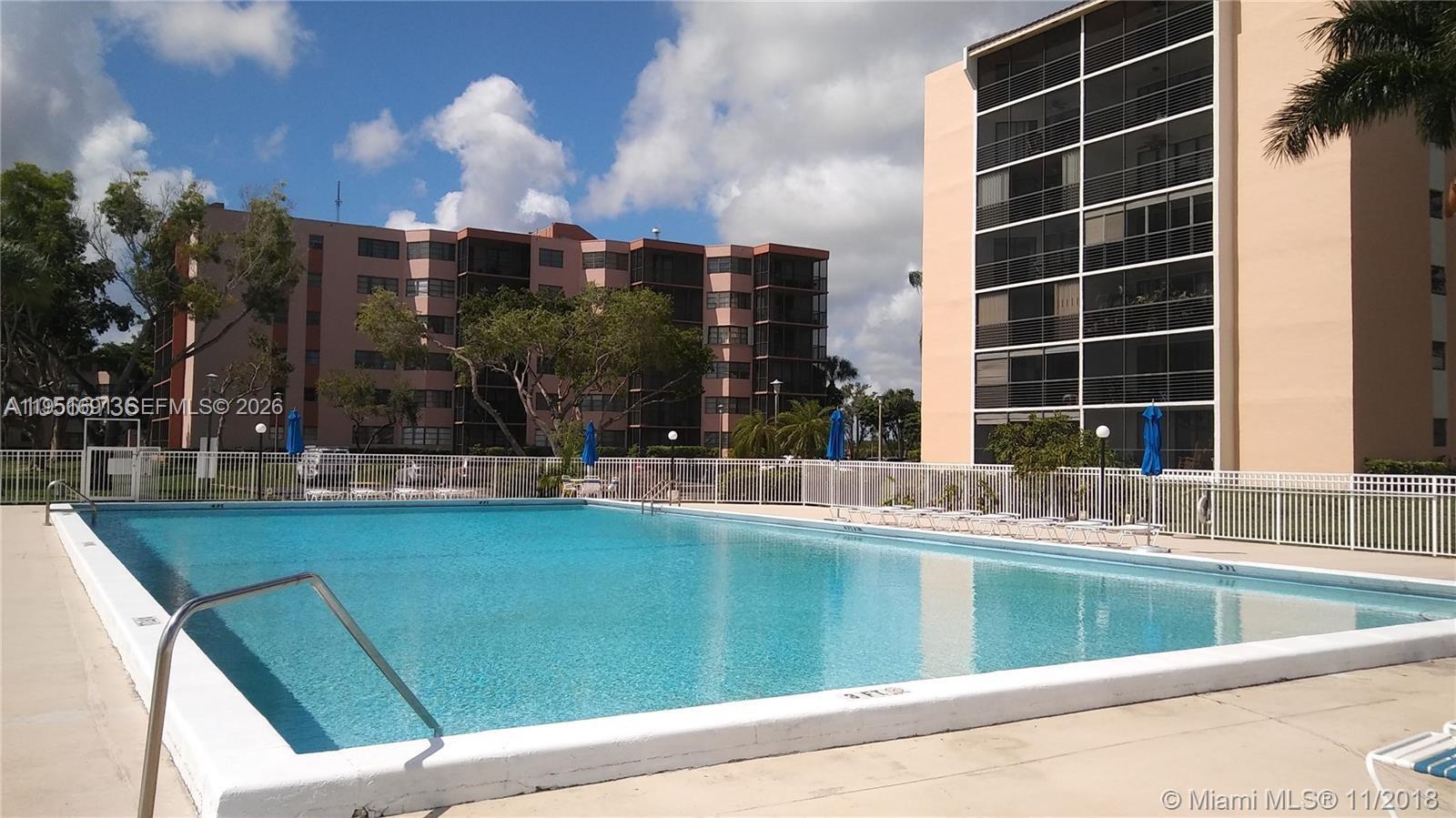 20840 San Simeon Way, Unit 702 Miami, FL 33179 - Photo 33 of 34 a view of swimming pool with outdoor seating and city view