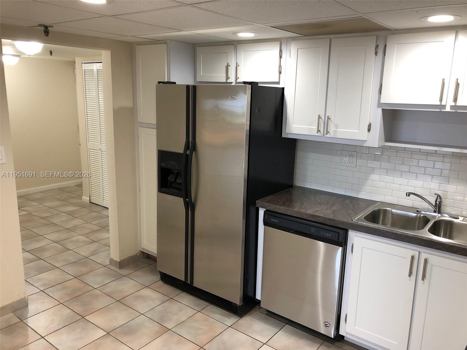 20840 San Simeon Way, Unit 702 Miami, FL 33179 - Photo 7 of 34 a kitchen with stainless steel appliances granite countertop a refrigerator and a sink
