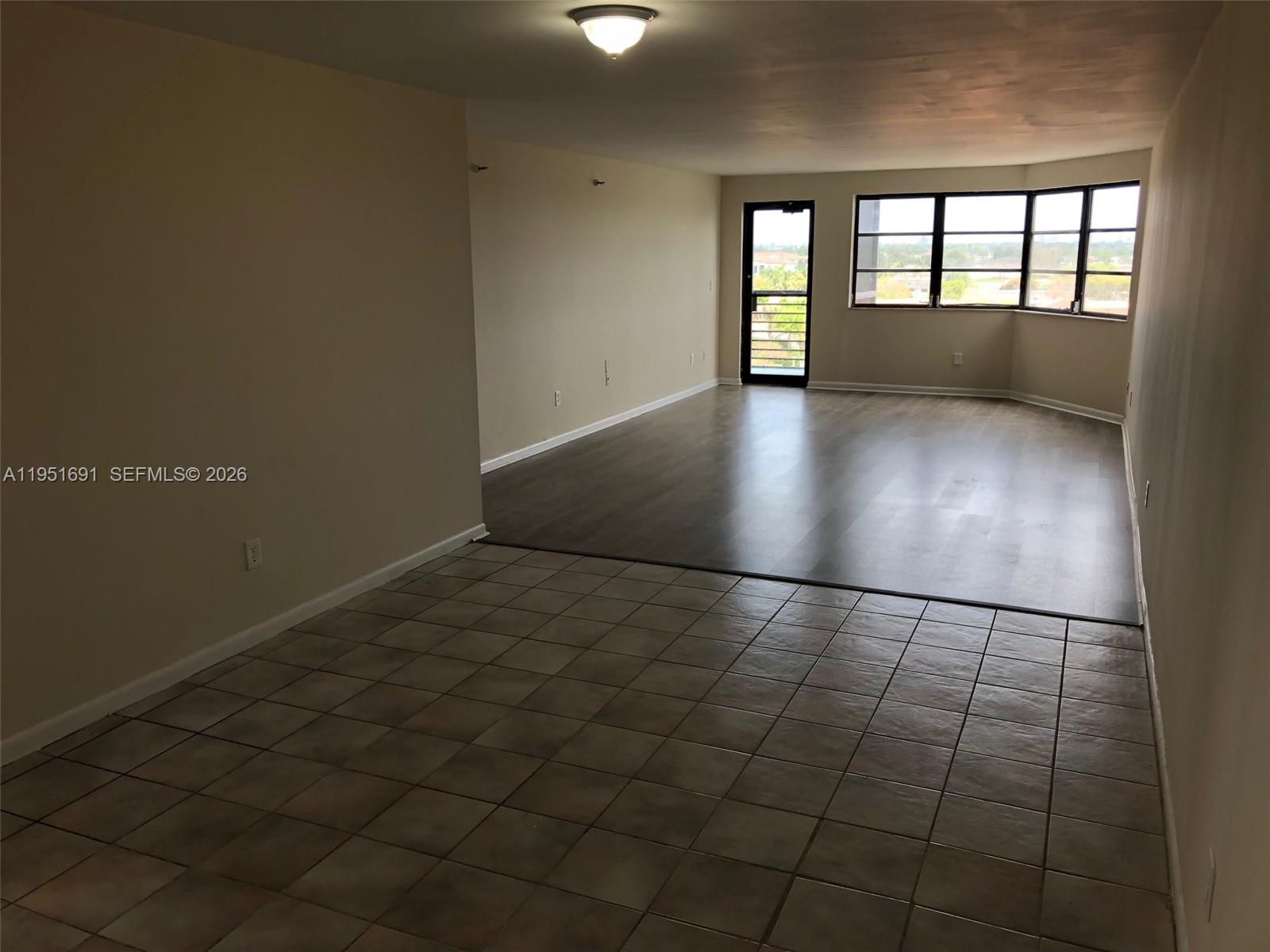 20840 San Simeon Way, Unit 702 Miami, FL 33179 - Photo 9 of 34 an empty room with windows