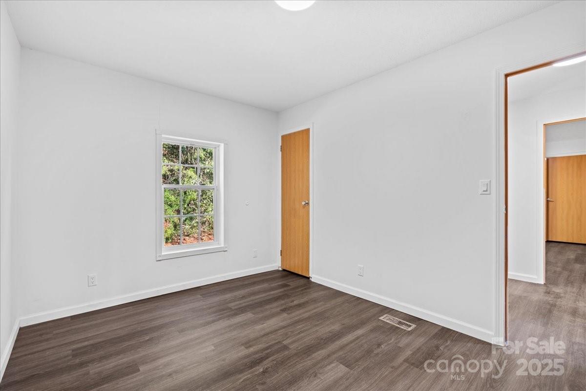 282 Bob Hardin Road Rutherfordton, NC 28139 - Photo 20 of 27 an empty room with wooden floor and a window