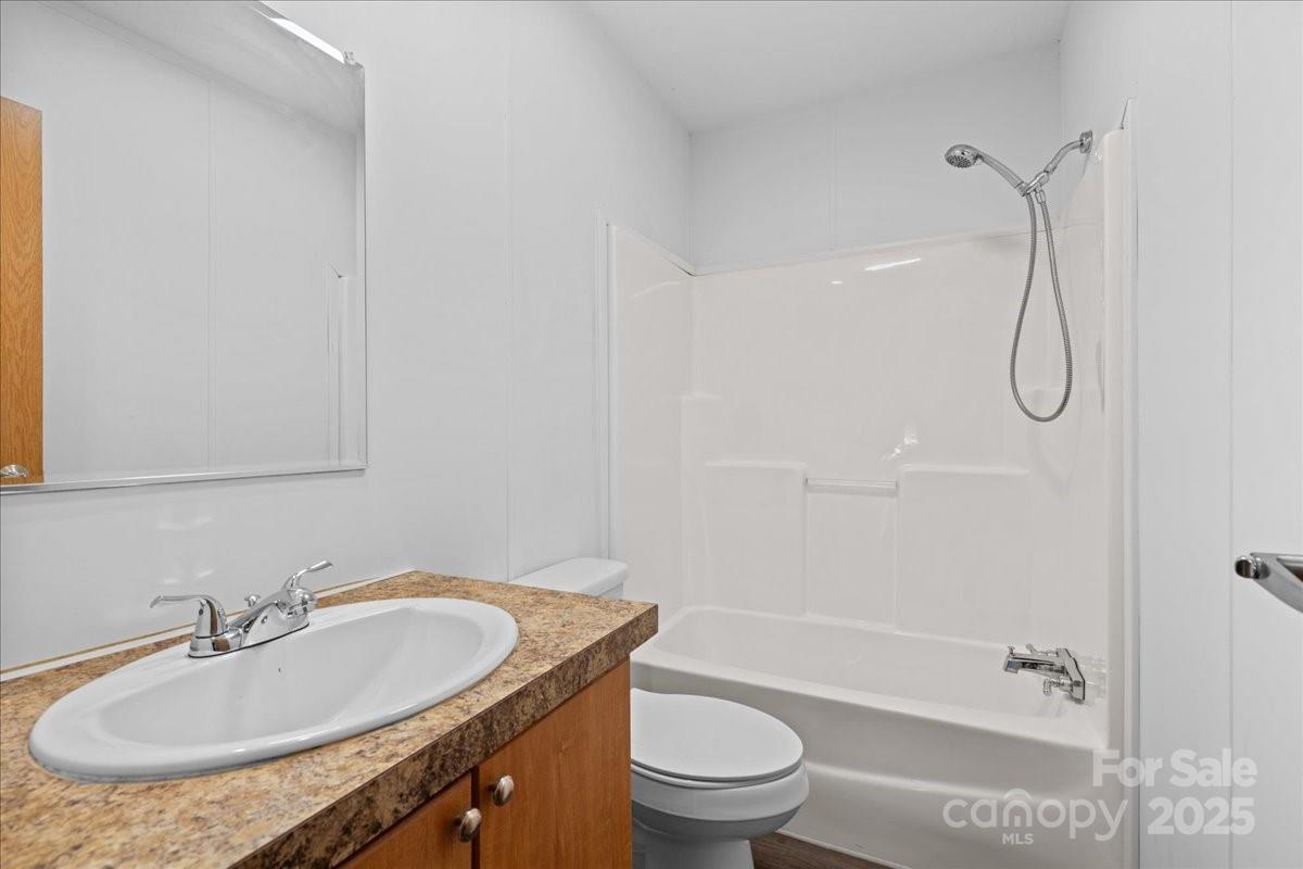 282 Bob Hardin Road Rutherfordton, NC 28139 - Photo 21 of 27 a bathroom with a granite countertop sink a toilet and shower