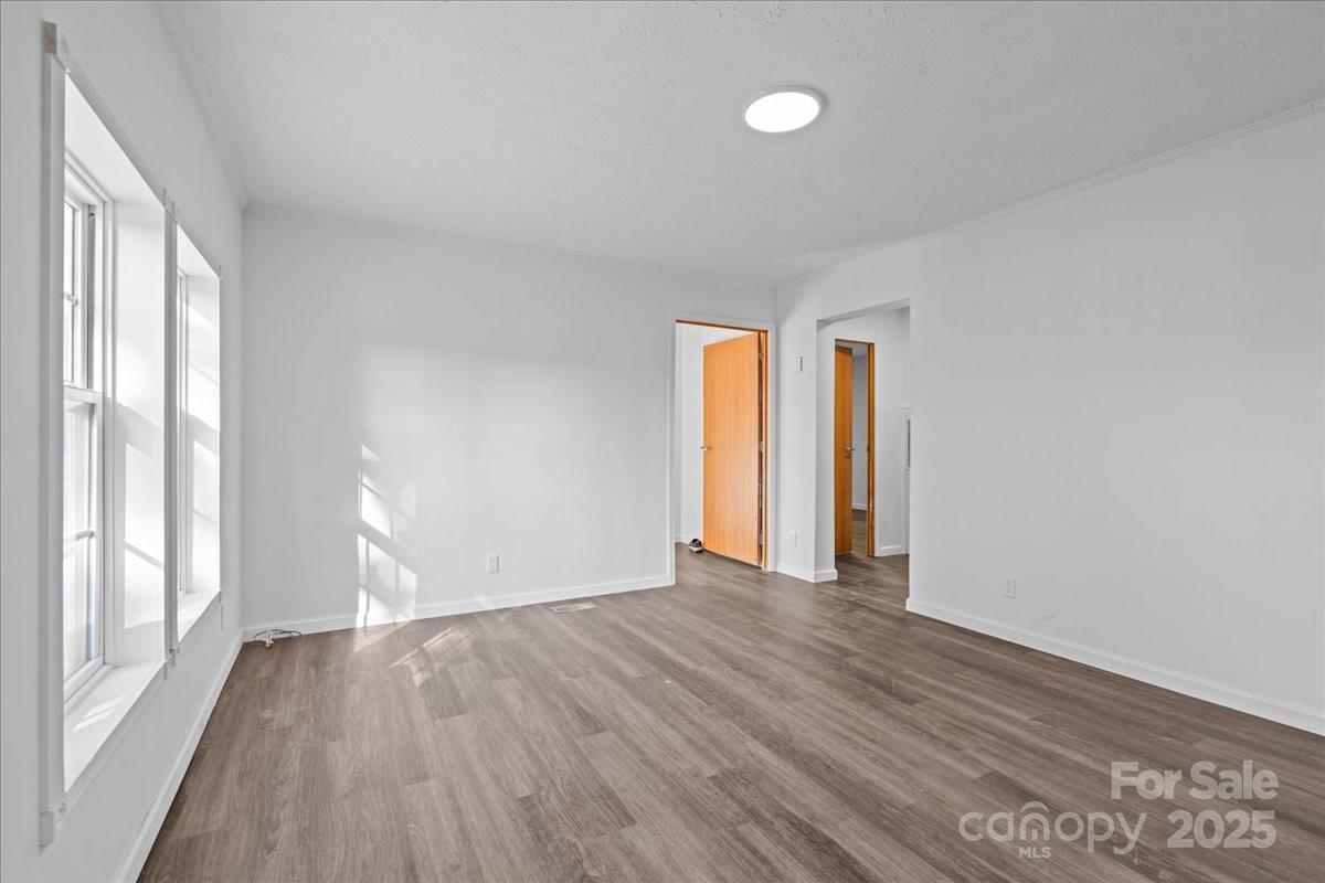 282 Bob Hardin Road Rutherfordton, NC 28139 - Photo 3 of 27 a view of an empty room with wooden floor and a window