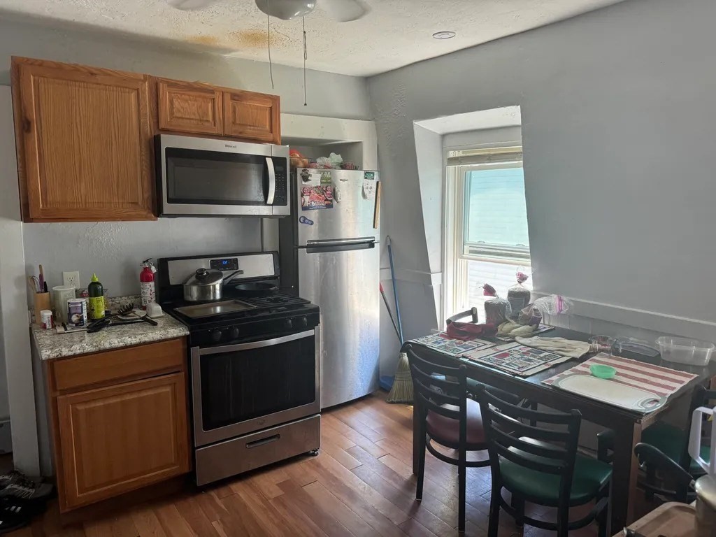 15 Goulding Street Worcester, MA 01609 - Photo 11 of 16 a kitchen with a stove and microwave