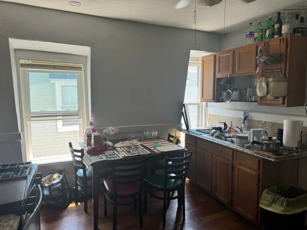 15 Goulding Street Worcester, MA 01609 - Photo 15 of 16 a kitchen with a table chairs stove and cabinets