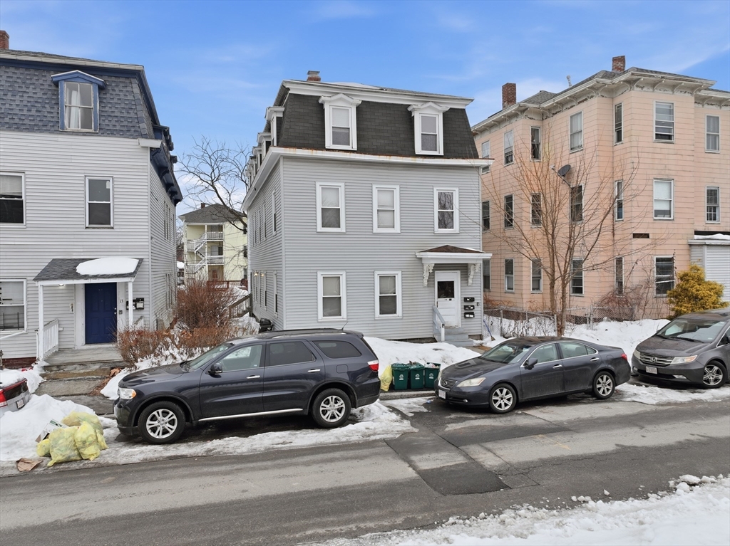 15 Goulding Street Worcester, MA 01609 - Photo 4 of 16 a car parked in front of a white house