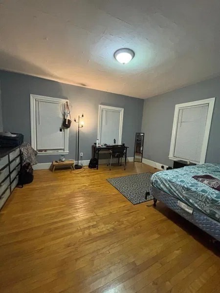 15 Goulding Street Worcester, MA 01609 - Photo 8 of 16 a bedroom with a bed and wooden floor