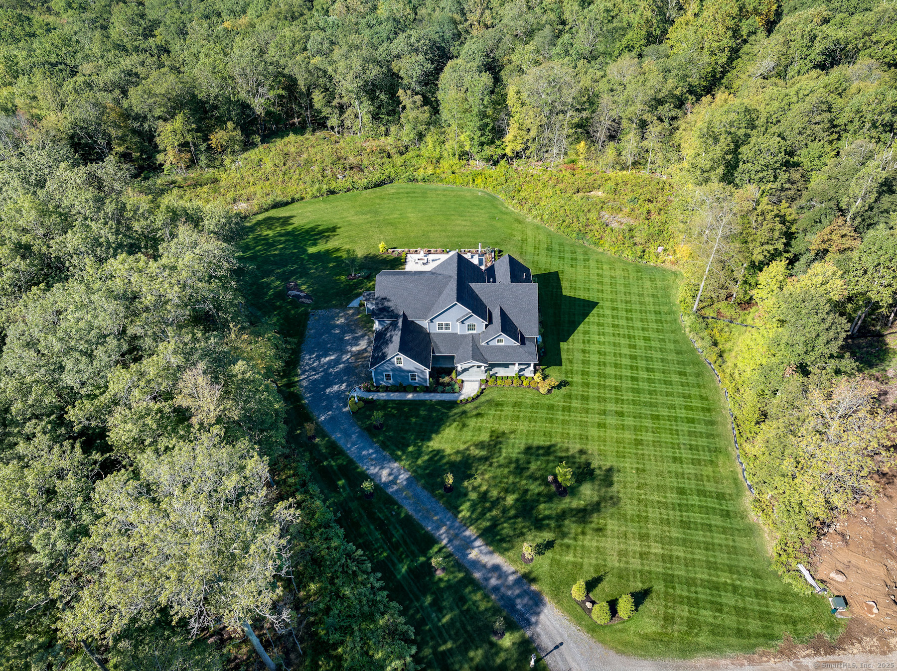an aerial view of a house with a yard