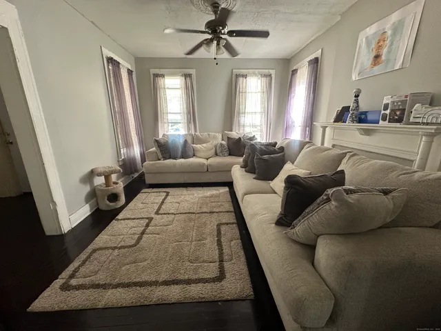 a living room with furniture rug and window