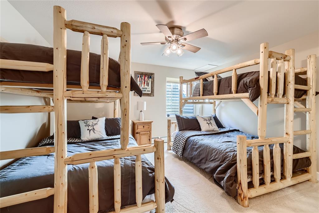 263 Saddle Ridge Drive, Unit 263 Silverthorne, CO 80498 - Photo 11 of 25 a bedroom with a large bed and a chandelier