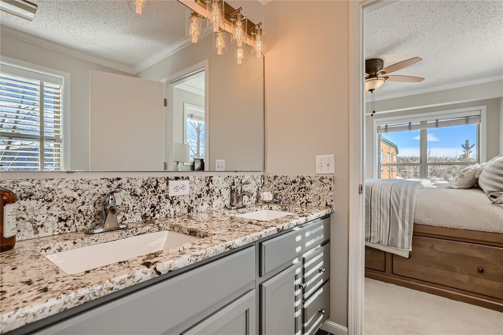 263 Saddle Ridge Drive, Unit 263 Silverthorne, CO 80498 - Photo 16 of 25 a bathroom with a granite countertop sink and a mirror