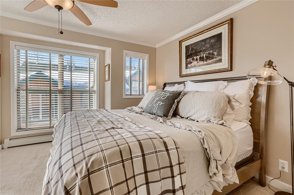 263 Saddle Ridge Drive, Unit 263 Silverthorne, CO 80498 - Photo 17 of 25 a large bed sitting in a bedroom next to a window
