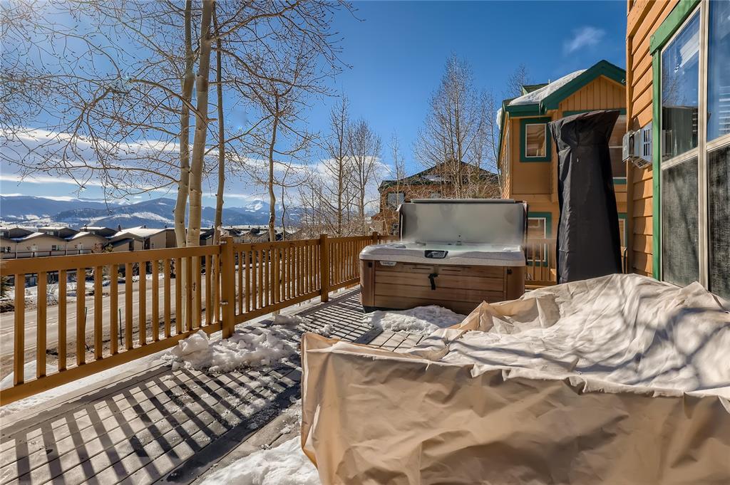 263 Saddle Ridge Drive, Unit 263 Silverthorne, CO 80498 - Photo 21 of 25 a bed sitting in a bedroom next to a larger window
