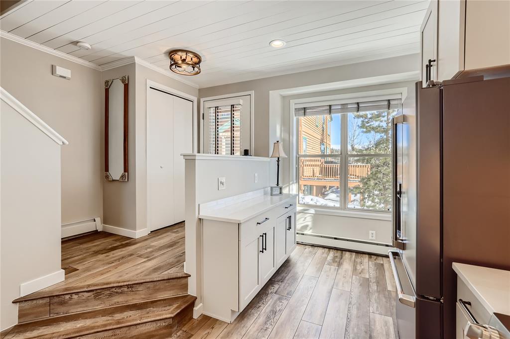 263 Saddle Ridge Drive, Unit 263 Silverthorne, CO 80498 - Photo 3 of 25 a kitchen with a refrigerator a stove top oven and a window