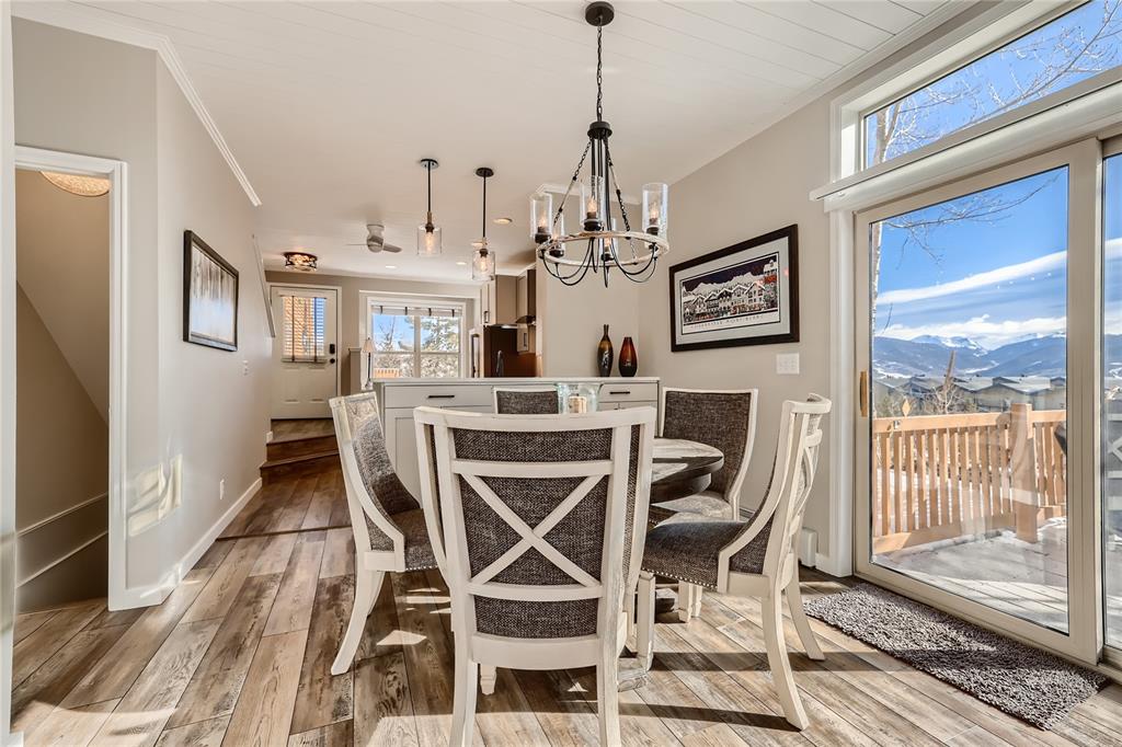 263 Saddle Ridge Drive, Unit 263 Silverthorne, CO 80498 - Photo 6 of 25 a view of a dining room with furniture wooden floor and chandelier