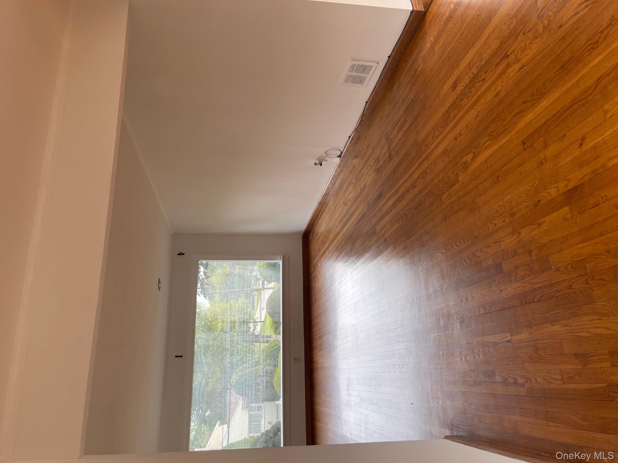 66 Laron Drive New Rochelle, NY 10804 - Photo 2 of 23 a view of room with wooden floor and window