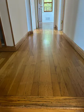 a view of a room with wooden floor and stairs