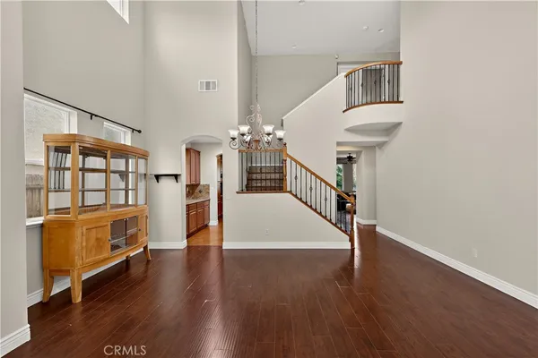a kitchen with stainless steel appliances granite countertop a stove top oven a sink dishwasher a refrigerator and cabinets with wooden floor