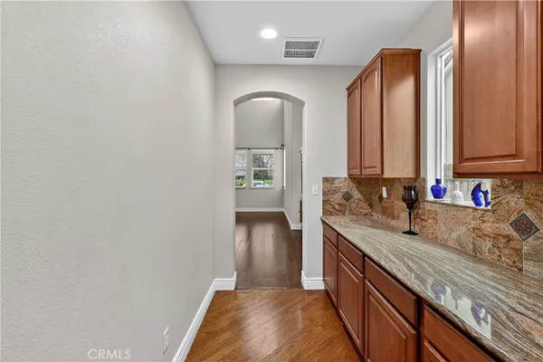 a kitchen with stainless steel appliances granite countertop a sink stove microwave and refrigerator