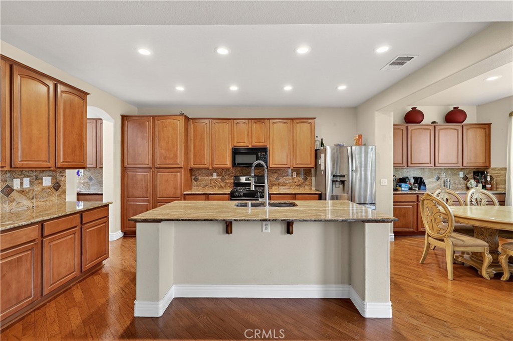 1277 Baxter Drive Merced, CA 95348 - Photo 13 of 63 a kitchen with counter top space a sink appliances and cabinets