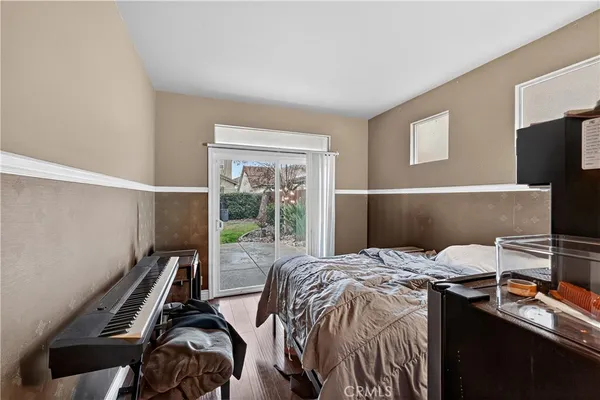 a view of a hallway with wooden floor and closet