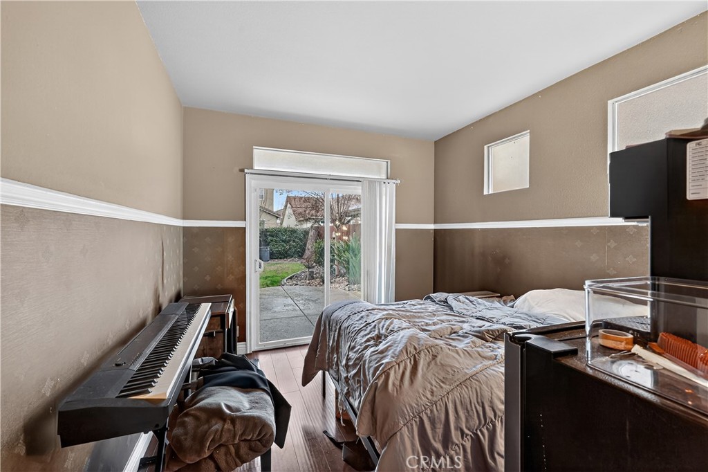 1277 Baxter Drive Merced, CA 95348 - Photo 26 of 63 a bedroom with a bed and a flat tv screen on the dresser