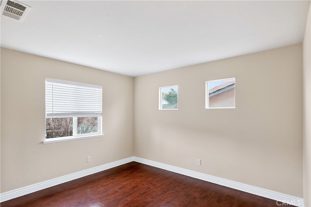 1277 Baxter Drive Merced, CA 95348 - Photo 32 of 63 a view of an empty room with wooden floor and a window