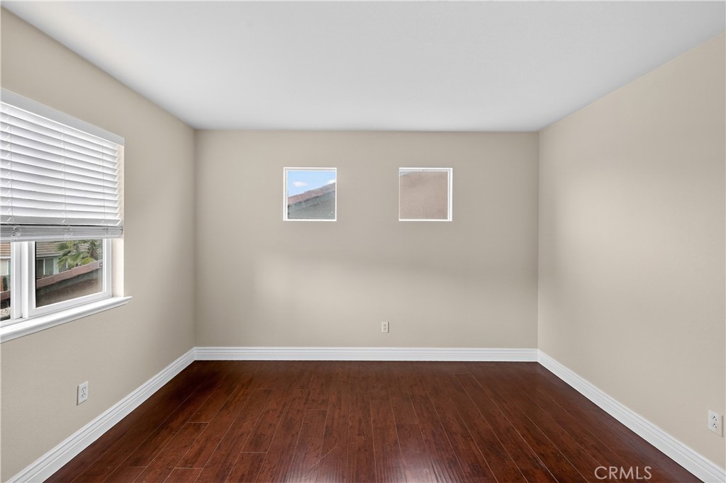 1277 Baxter Drive Merced, CA 95348 - Photo 34 of 63 a view of an empty room with wooden floor and a window