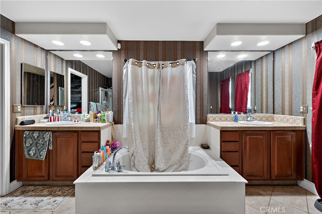 1277 Baxter Drive Merced, CA 95348 - Photo 37 of 63 a bathroom with a tub sink shower and mirror