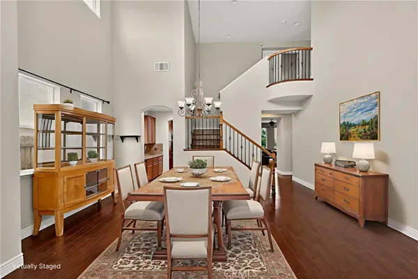 a dining room with wooden floor and furniture